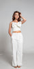 Crop top color blanco con detalle de moño cruzado. 